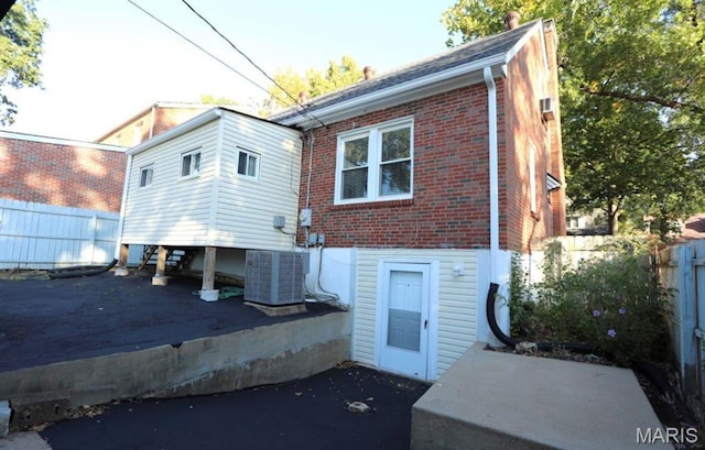 7710 Saint Albans Ave, Maplewood, MO 63117 - back of house featuring central AC unit, brick siding, and a patio
