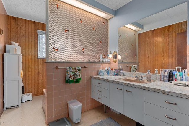 bathroom featuring wood walls and vanity