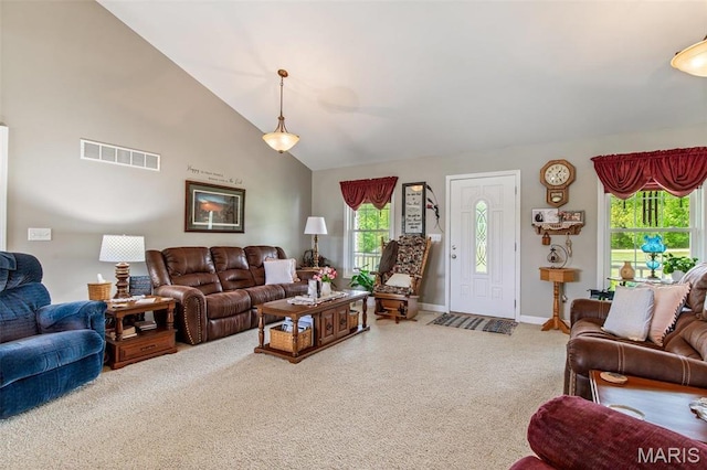 carpeted living area featuring high vaulted ceiling and baseboards
