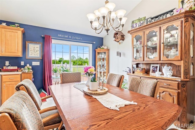 dining room with lofted ceiling and a chandelier