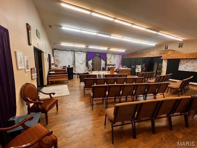 misc room with wood finished floors and vaulted ceiling