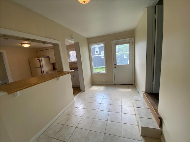 1309 Belton Ave, Webster Groves, MO 63119 - doorway featuring plenty of natural light, baseboards, and light tile patterned floors