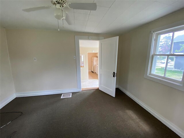1309 Belton Ave, Webster Groves, MO 63119 - spare room featuring dark colored carpet, baseboards, and ceiling fan
