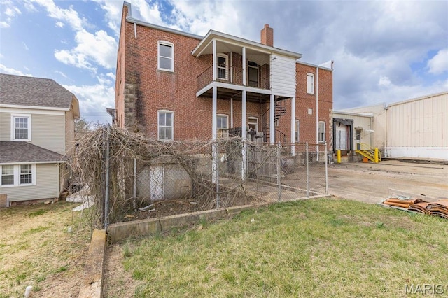 702 Benham St, Bonne Terre, MO 63628 - rear view of house with a chimney, brick siding, and a balcony