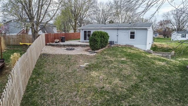rear view of property featuring a patio, cooling unit, and a shingled roof