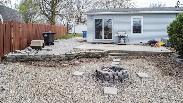 view of yard featuring an outdoor fire pit, fence, a patio, and central air condition unit