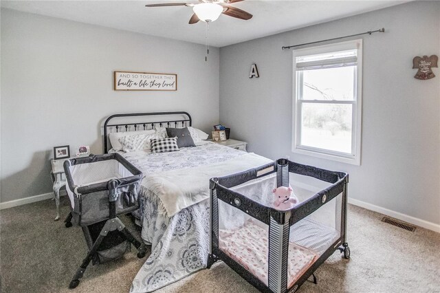carpeted bedroom featuring baseboards and a ceiling fan