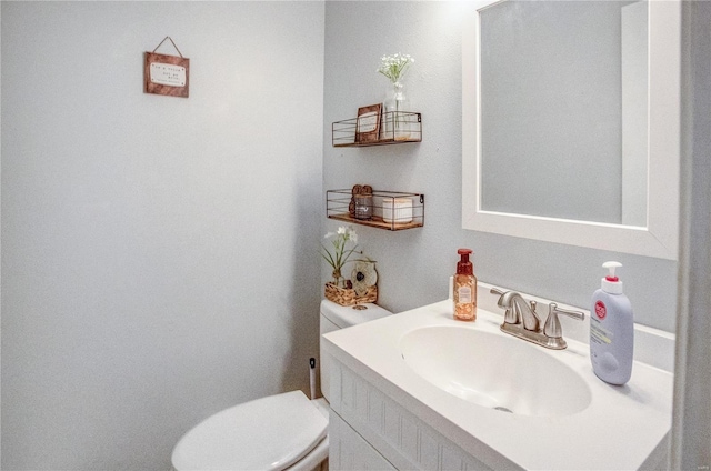 half bathroom with toilet and vanity