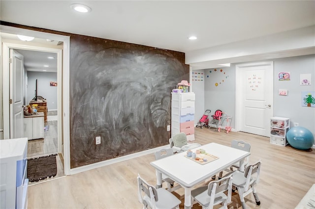 game room with light wood-style floors and recessed lighting