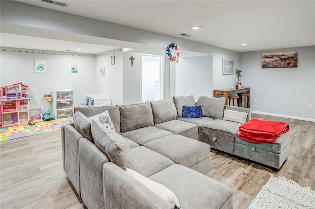 living area with wood finished floors, recessed lighting, and baseboards