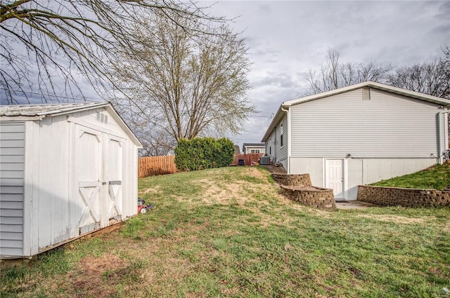 view of yard featuring a shed, an outbuilding, and central AC unit