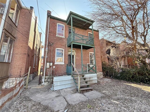 3949 Palm St, Saint Louis, MO 63107 - back of property with a balcony and brick siding