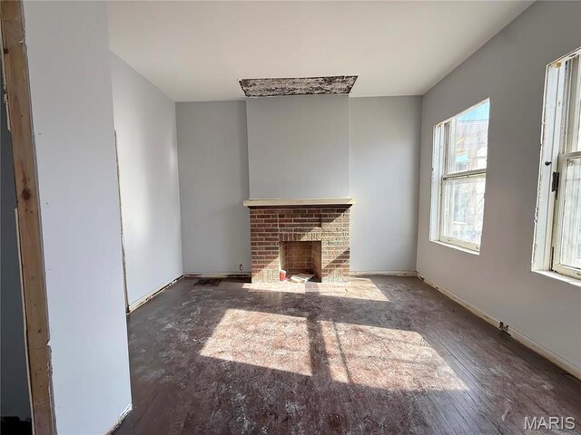 3949 Palm St, Saint Louis, MO 63107 - unfurnished living room with a brick fireplace