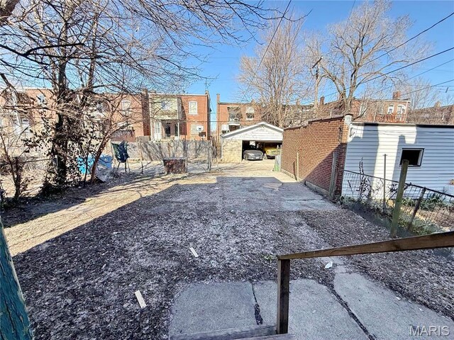 3949 Palm St, Saint Louis, MO 63107 - view of yard with a carport and fence