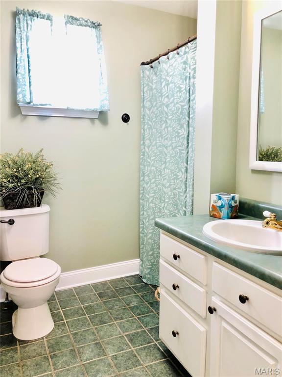 3579 Boswell, St John, MO 63114 - full bath with vanity, toilet, and baseboards