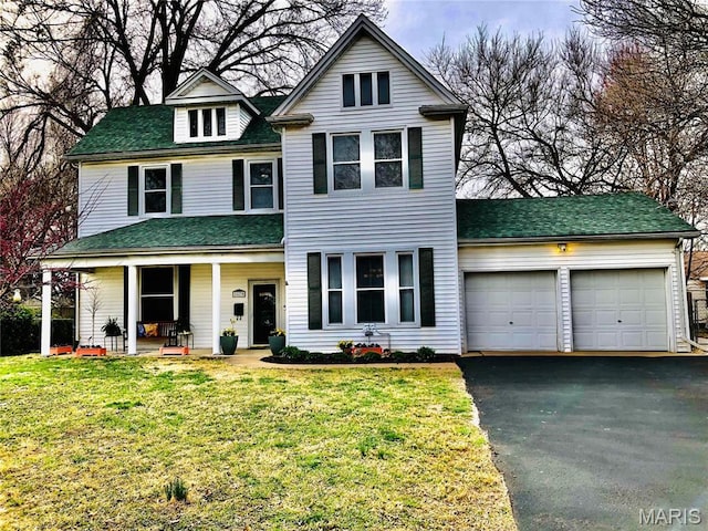 3579 Boswell, St John, MO 63114 - view of front of property featuring a porch, an attached garage, driveway, and a front yard