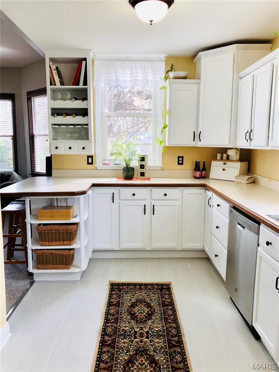 3579 Boswell, St John, MO 63114 - kitchen featuring dishwasher, open shelves, white cabinetry, and light countertops
