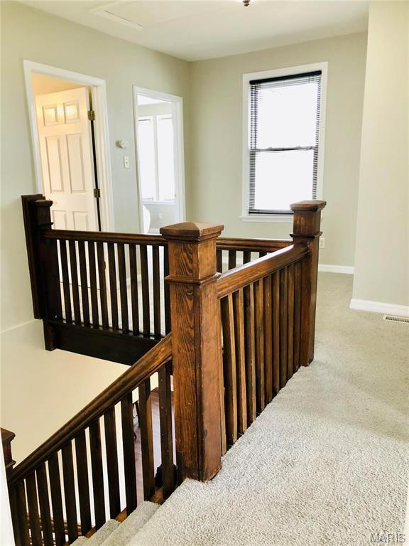 3579 Boswell, St John, MO 63114 - stairway featuring carpet and baseboards