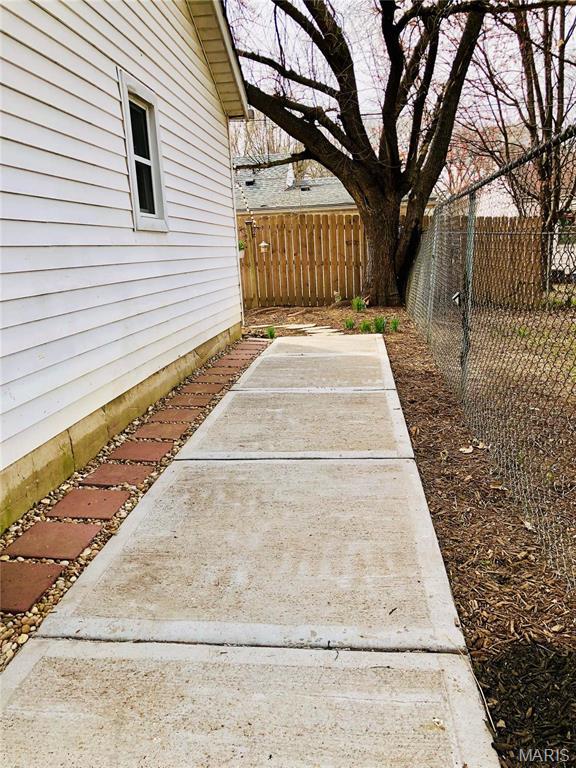 3579 Boswell, St John, MO 63114 - fenced backyard featuring a patio