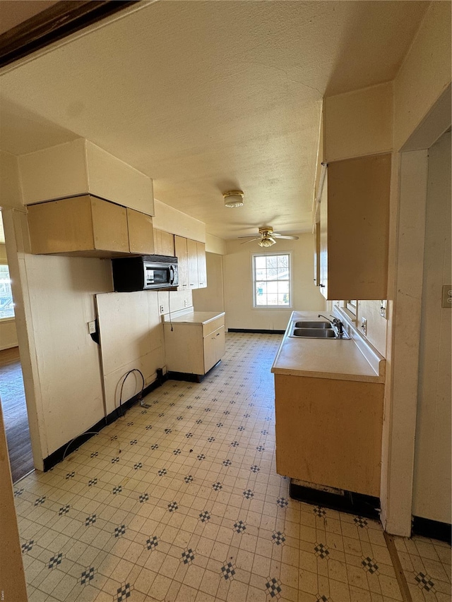 445 Manion, Sullivan, MO 63080 - kitchen with a sink, a ceiling fan, black microwave, light countertops, and a peninsula