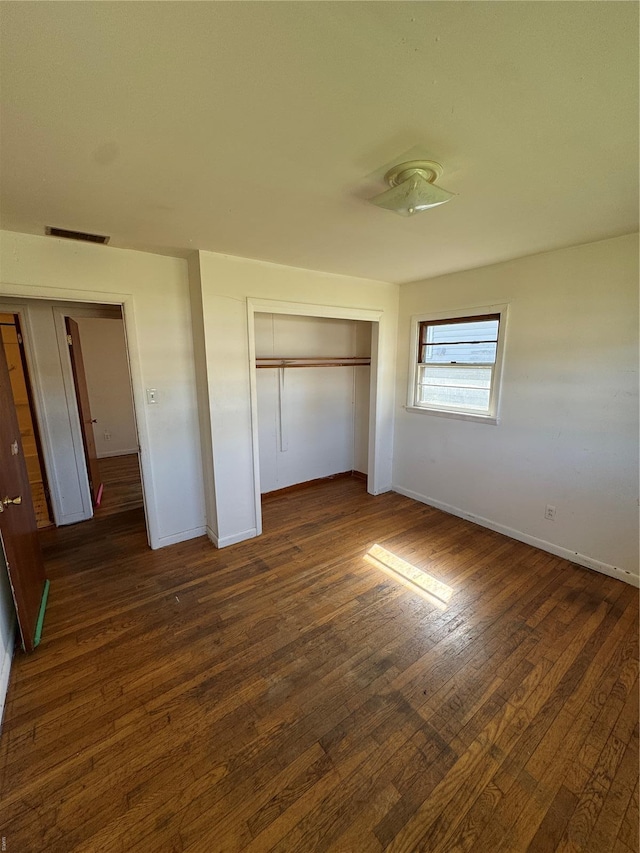 445 Manion, Sullivan, MO 63080 - unfurnished bedroom featuring dark wood-style flooring, a closet, and baseboards