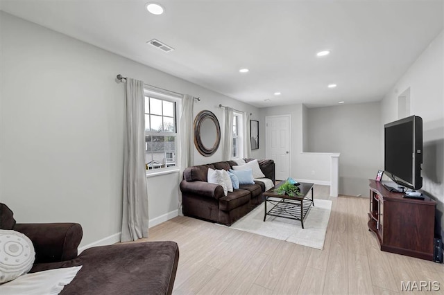 9003 Cardinal Ter, Saint Louis, MO 63144 - living room with light wood finished floors, baseboards, and recessed lighting