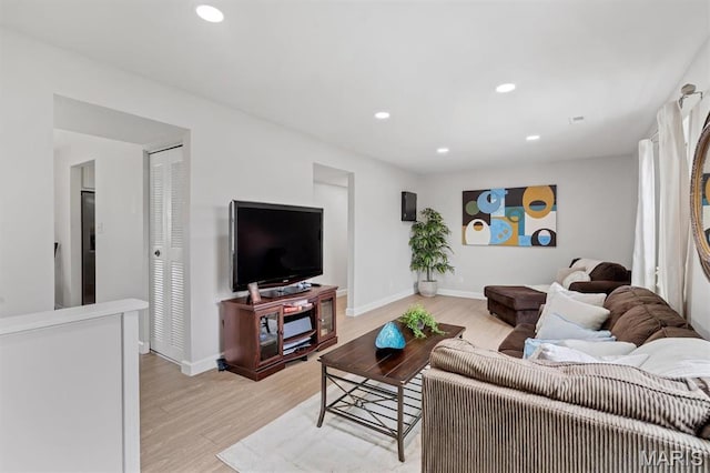 9003 Cardinal Ter, Saint Louis, MO 63144 - living area featuring light wood-style flooring, recessed lighting, and baseboards