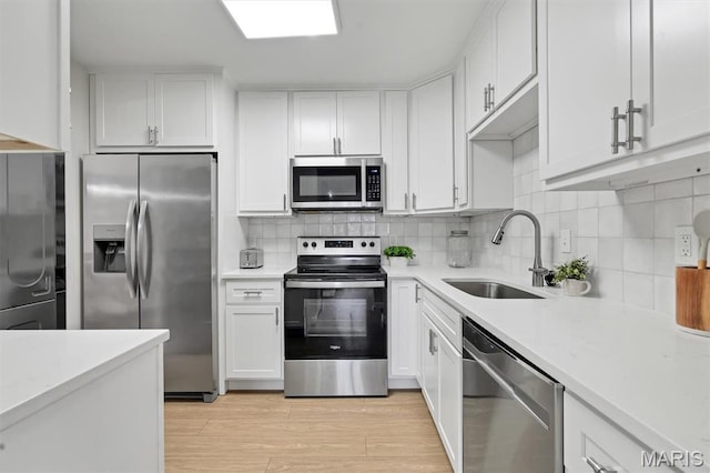 9003 Cardinal Ter, Saint Louis, MO 63144 - kitchen with stainless steel appliances, a sink, and light countertops
