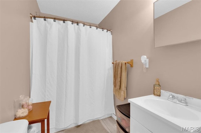 full bathroom with curtained shower and vanity