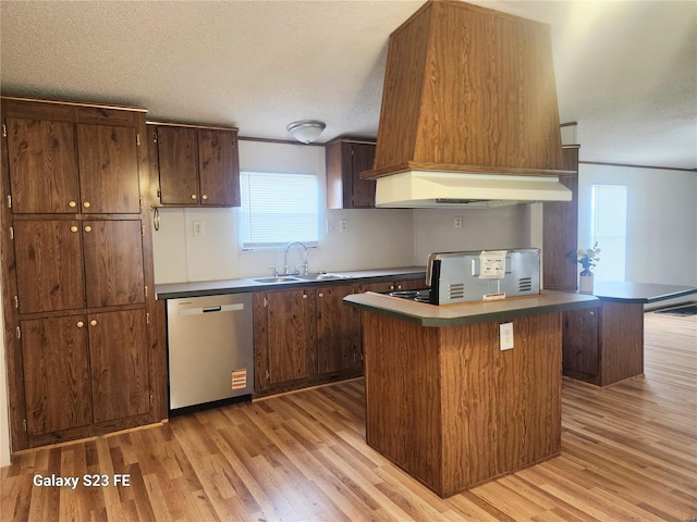 209 Sentry Oaks, Union, MO 63084 - kitchen featuring stainless steel dishwasher, a sink, light wood finished floors, a textured ceiling, and exhaust hood