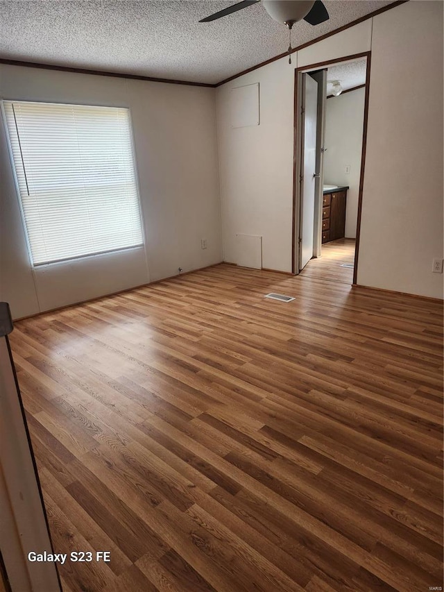 209 Sentry Oaks, Union, MO 63084 - empty room featuring wood finished floors, a ceiling fan, and a textured ceiling