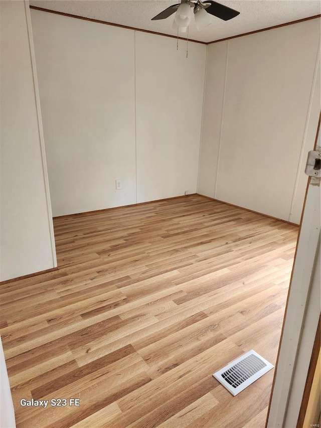 209 Sentry Oaks, Union, MO 63084 - spare room with ceiling fan, light wood-type flooring, a textured ceiling, and crown molding