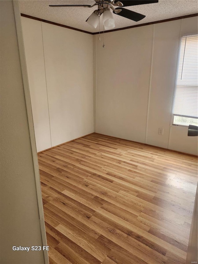 209 Sentry Oaks, Union, MO 63084 - unfurnished room with a textured ceiling, ceiling fan, light wood-style flooring, and crown molding