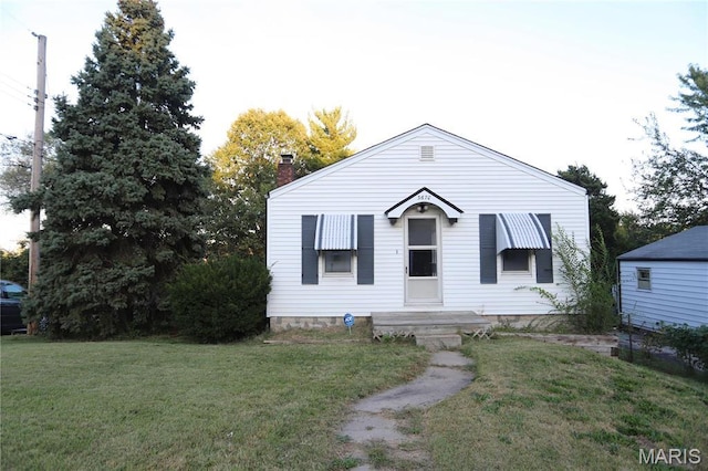 3670 E Edgar Ave, Saint Louis, MO 63121 - view of front of house with a front lawn and a chimney