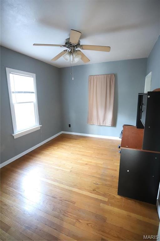 3670 E Edgar Ave, Saint Louis, MO 63121 - unfurnished bedroom with light wood-style flooring and a ceiling fan