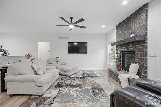 19011 Pinckney Manor Ct, Warrenton, MO 63383 - living area with wood finished floors, ceiling fan, recessed lighting, and a fireplace