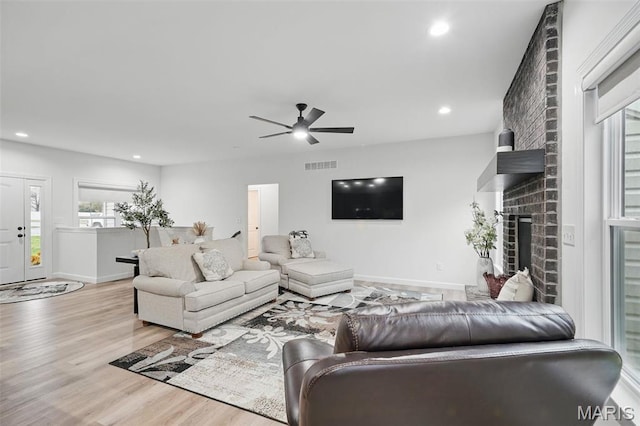 19011 Pinckney Manor Ct, Warrenton, MO 63383 - living area with a ceiling fan, wood finished floors, baseboards, recessed lighting, and a brick fireplace