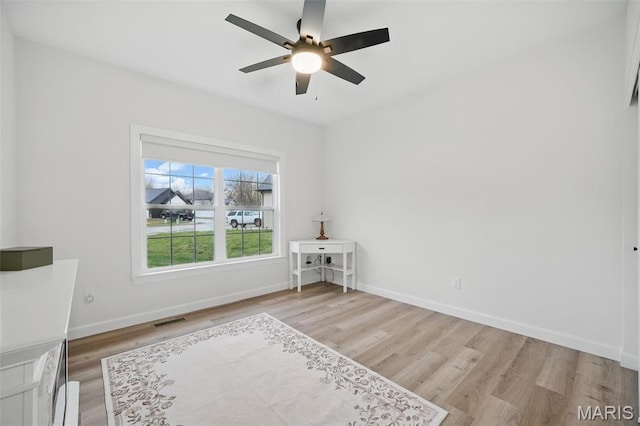 19011 Pinckney Manor Ct, Warrenton, MO 63383 - unfurnished bedroom with light wood-style floors, baseboards, and ceiling fan