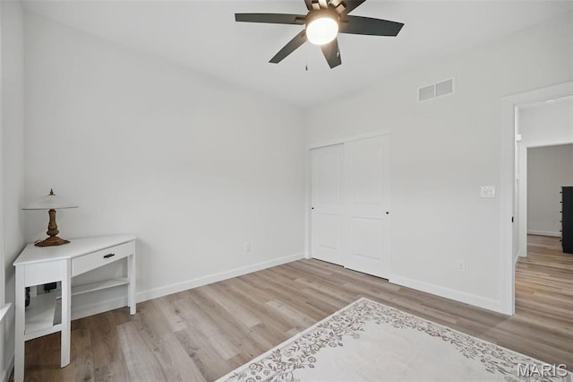 19011 Pinckney Manor Ct, Warrenton, MO 63383 - unfurnished bedroom with wood finished floors, baseboards, a ceiling fan, and a closet