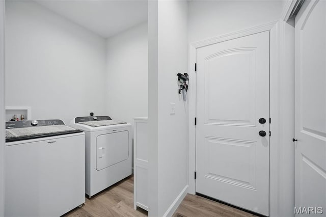 19011 Pinckney Manor Ct, Warrenton, MO 63383 - laundry area featuring washer and clothes dryer and light wood finished floors