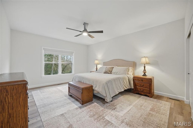 19011 Pinckney Manor Ct, Warrenton, MO 63383 - bedroom featuring light wood-style floors, baseboards, and ceiling fan