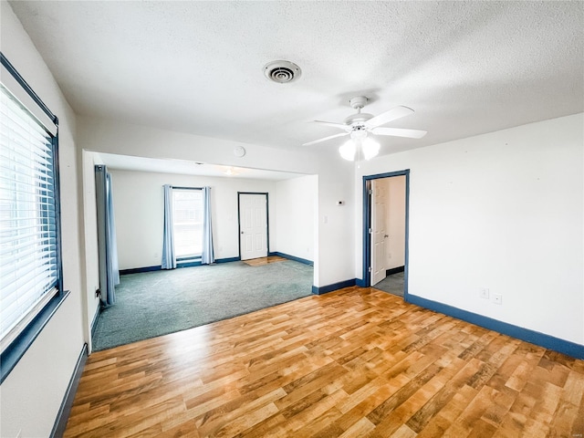 791 E Adams St, Nashville, IL 62263 - spare room featuring wood finished floors, baseboards, ceiling fan, and a textured ceiling