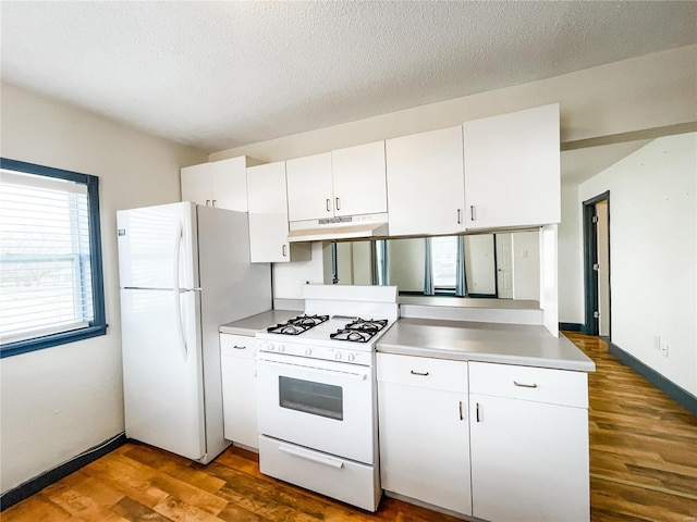 791 E Adams St, Nashville, IL 62263 - kitchen with white appliances, under cabinet range hood, dark wood-style floors, white cabinets, and a textured ceiling
