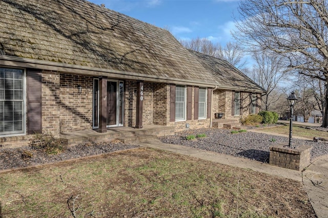 rear view of property with brick siding