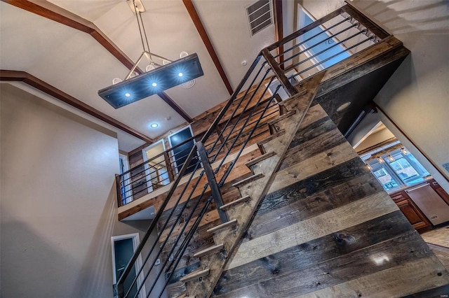 staircase featuring a high ceiling