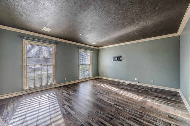 unfurnished room featuring ornamental molding, a textured ceiling, wood finished floors, and baseboards