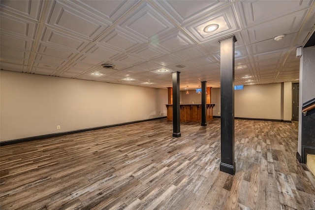 finished basement featuring wood finished floors and baseboards