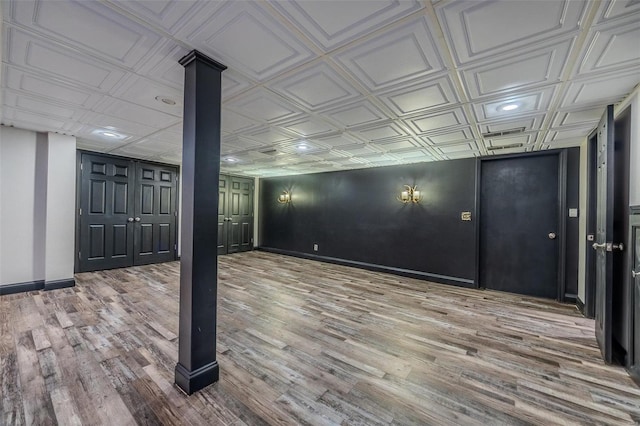 finished below grade area featuring an ornate ceiling, wood finished floors, baseboards, and recessed lighting