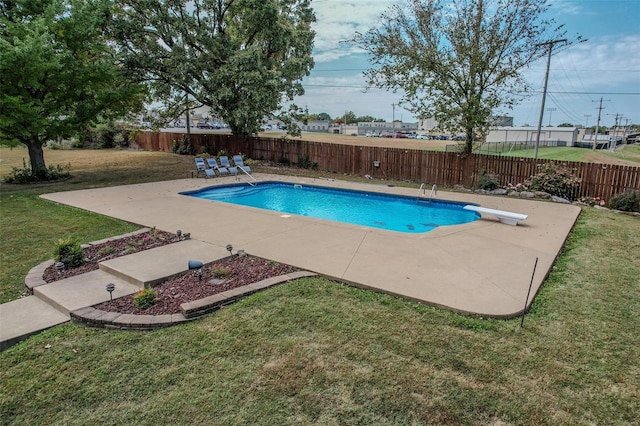 view of pool with a patio and a diving board