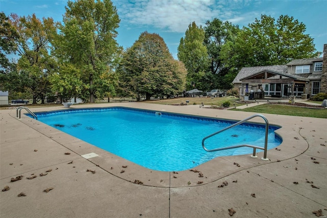 outdoor pool with a patio area